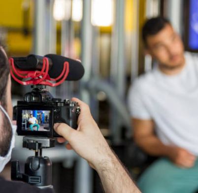 Videographer With Surgical Mask Behind The Camera