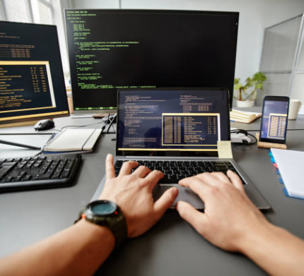 POV of QA engineer typing on keyboard while using computer at workplace in office, copy space